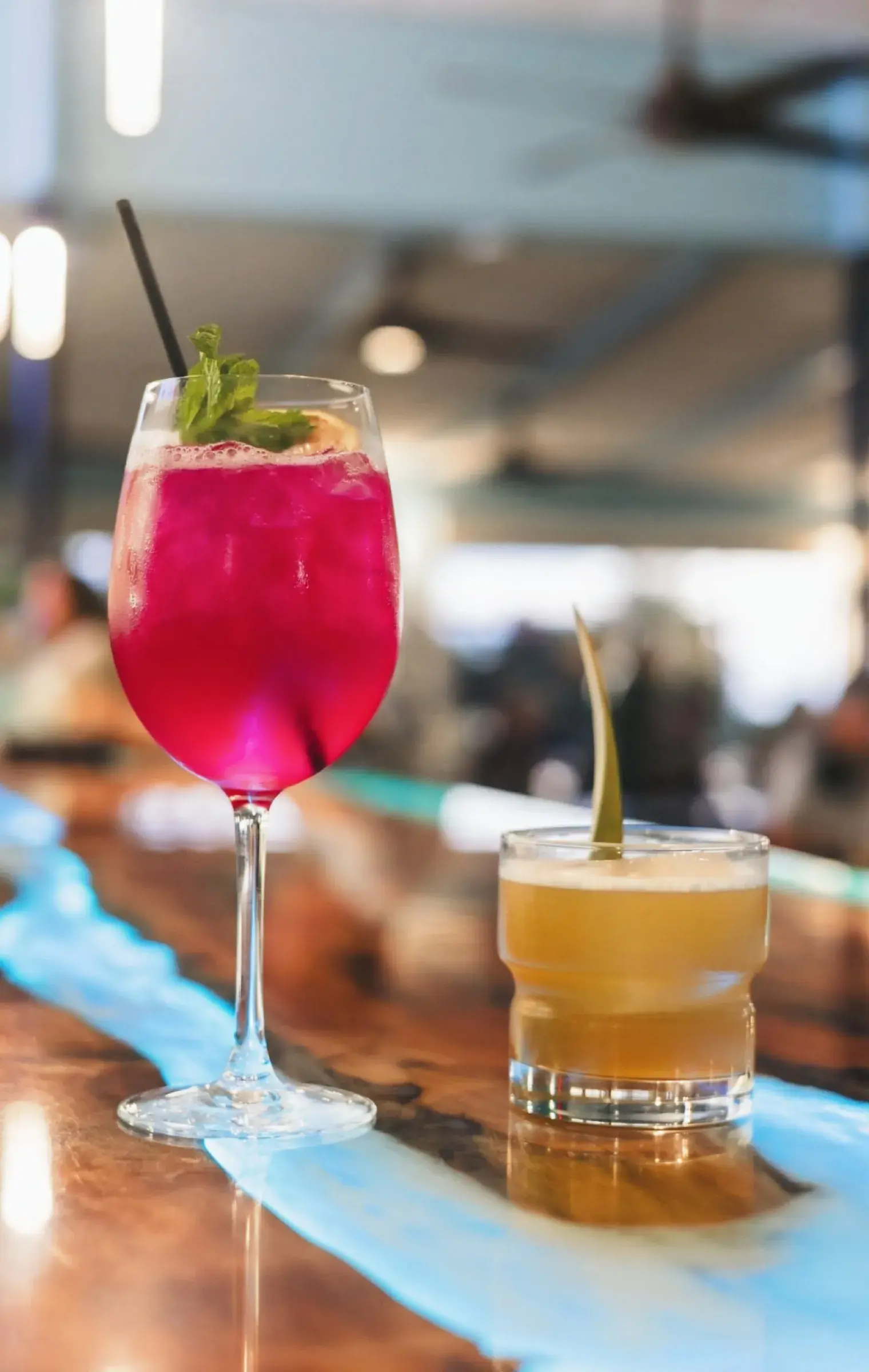 Pair of handcrafted cocktails on the live-edge bar top at Jackie Rey's Kona.