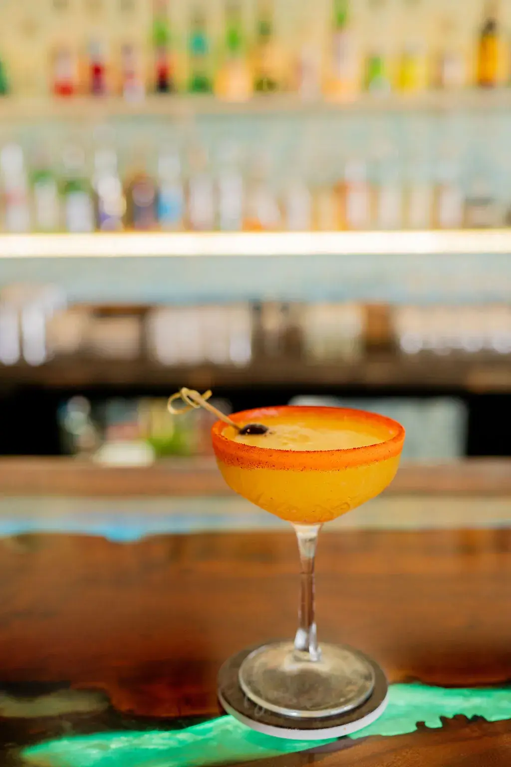 Coupe cocktail with a red salt rim at Jackie Rey's Kona bar.