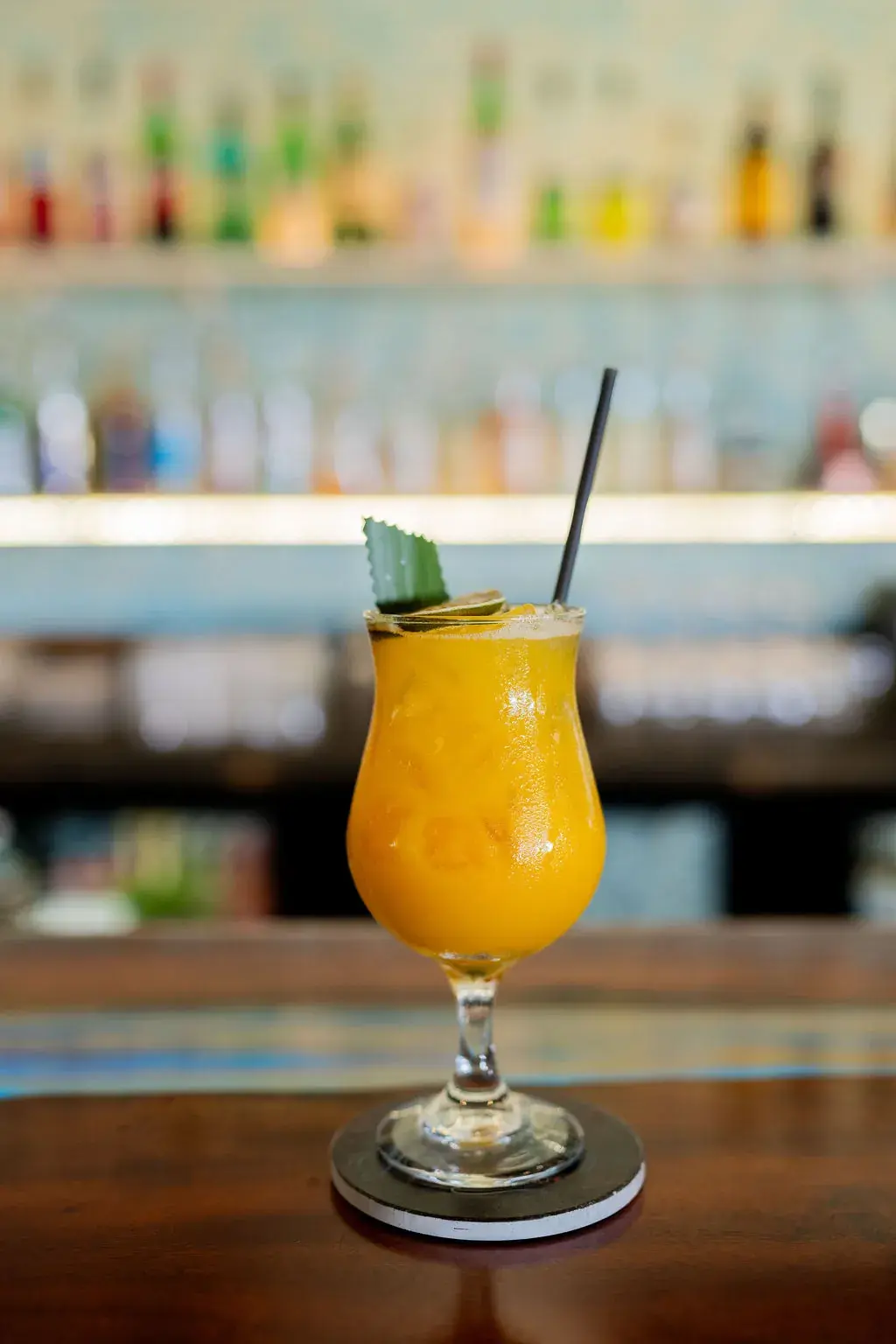 Frozen mango tropical cocktail in a hurricane glass at Jackie Rey's Kona.