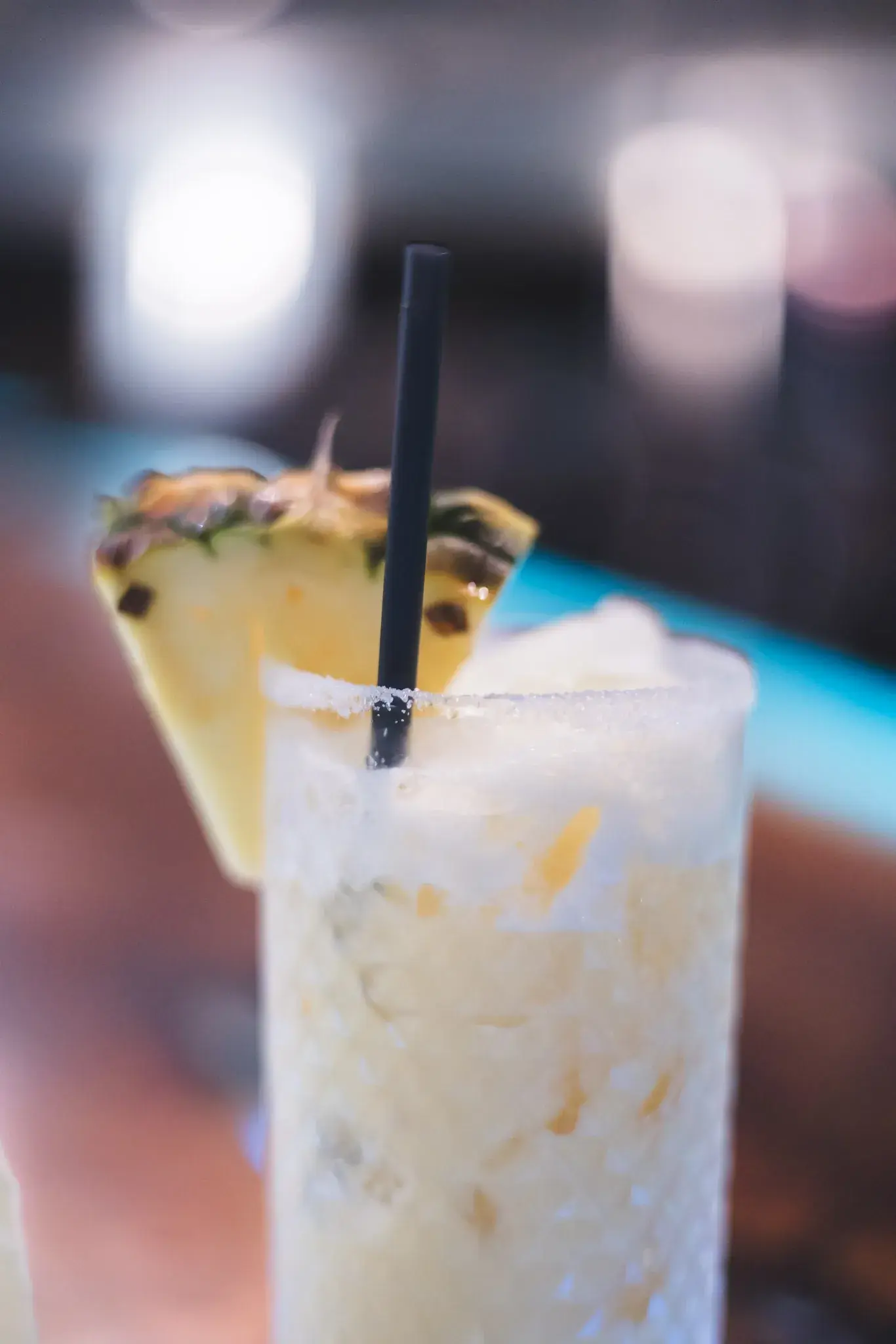 Piña colada–style tiki cocktail with a pineapple wedge at Jackie Rey's Kona.