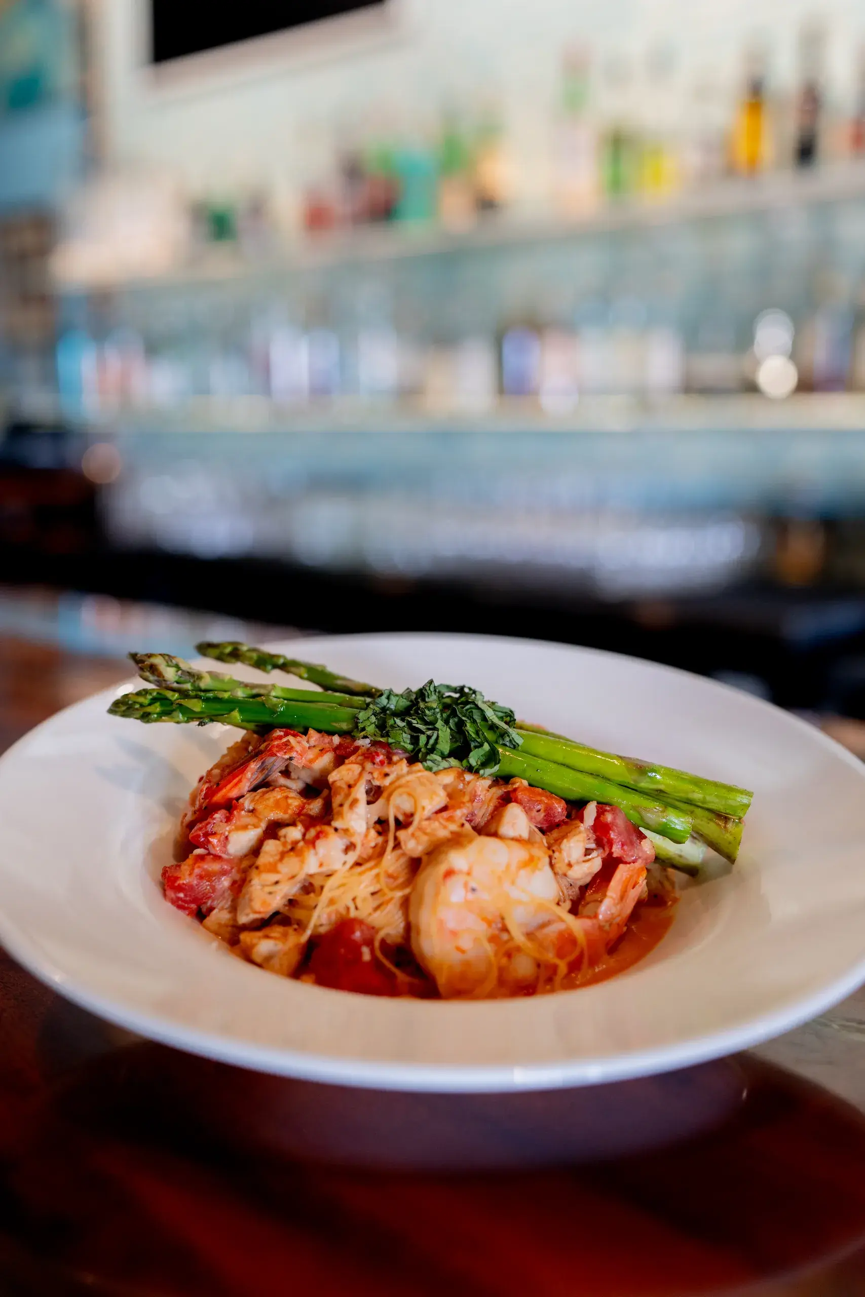 Chicken & Jumbo Shrimp at Jackie Rey's Ohana Grill, Tomato cream sauce, grilled asparagus, angel hair, parmesan.