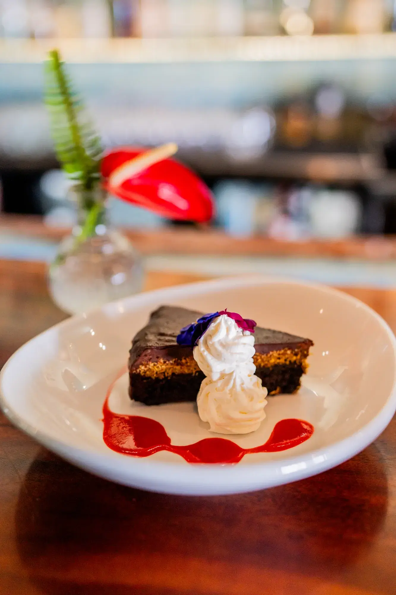 Chocolate & Pistachio Torte at Jackie Rey's Ohana Grill, Flourless chocolate torte, pistachio butter, kataifi chocolate ganache, whipped cream, strawberry purée, Kona coffee gelato.