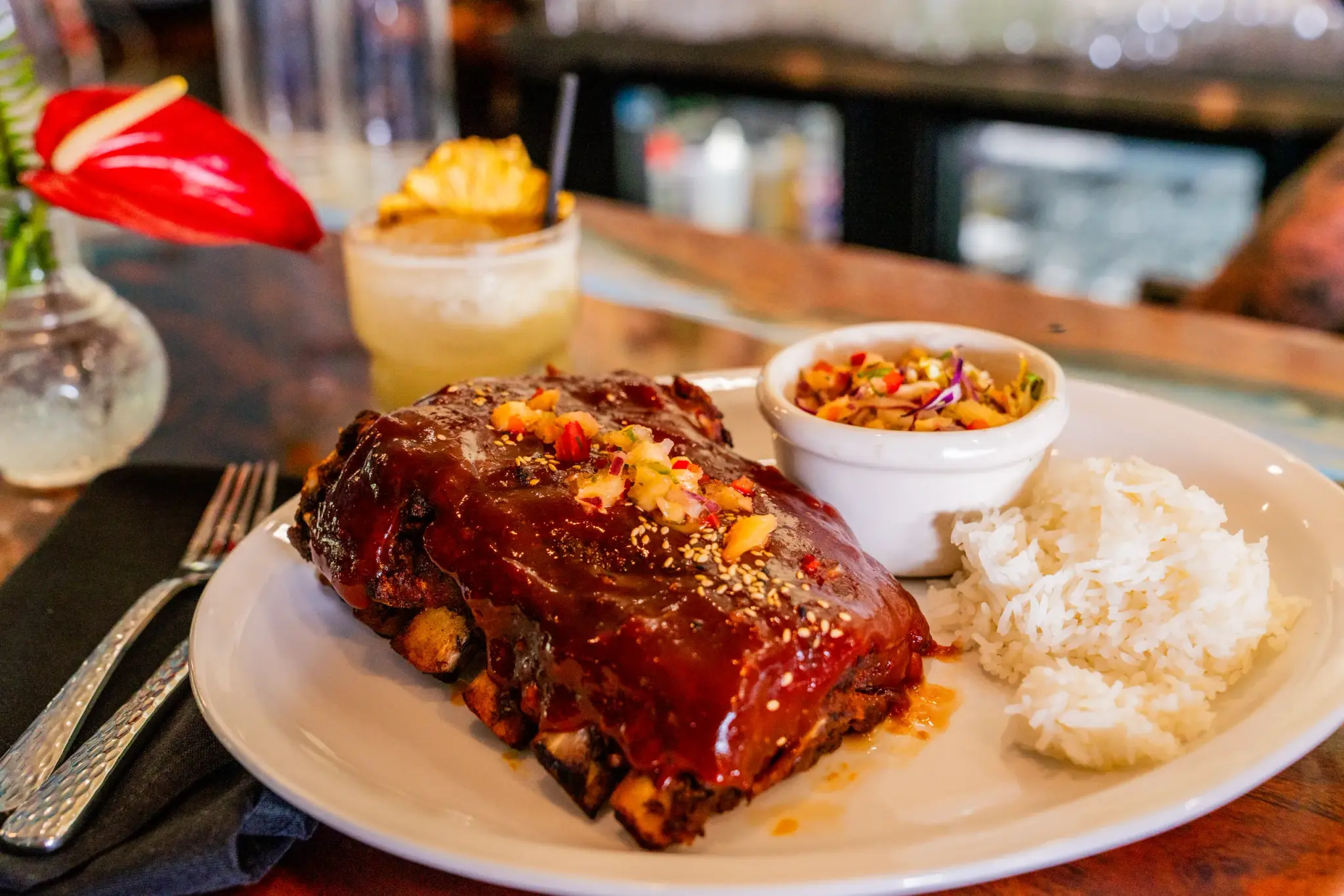 Guava BBQ Ribs at Jackie Rey's Ohana Grill, Half rack ribs, pineapple-coconut slaw, jasmine rice, pineapple relish.