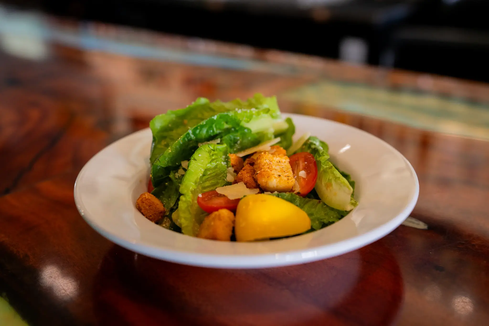 House Caesar at Jackie Rey's Ohana Grill, Romaine, house croutons, grape tomato, parmesan, Caesar dressing.