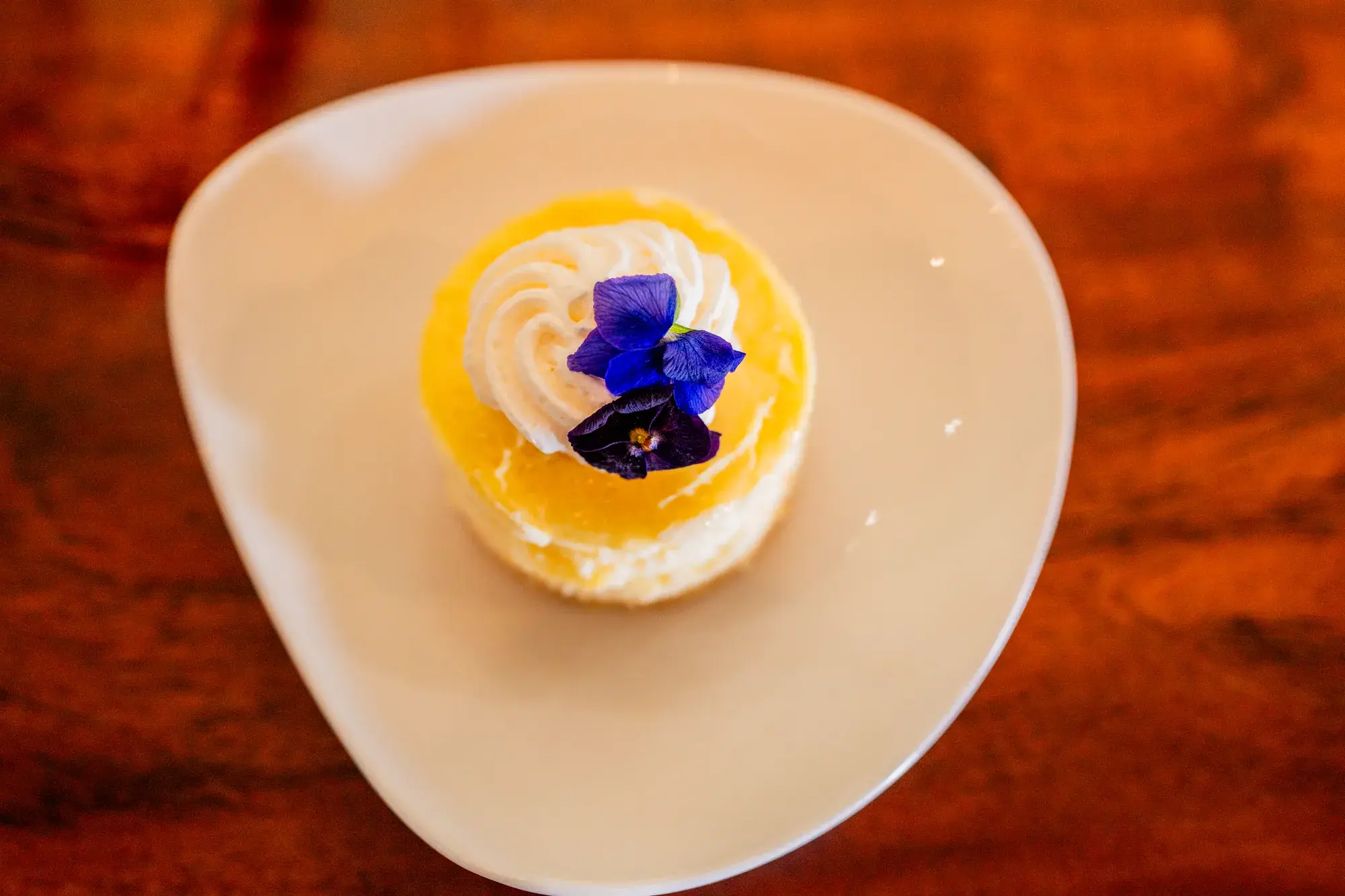 Lilikoi Cheesecake at Jackie Rey's Ohana Grill, Mac-nut shortbread crust, whipped cream, lilikoi glaze.