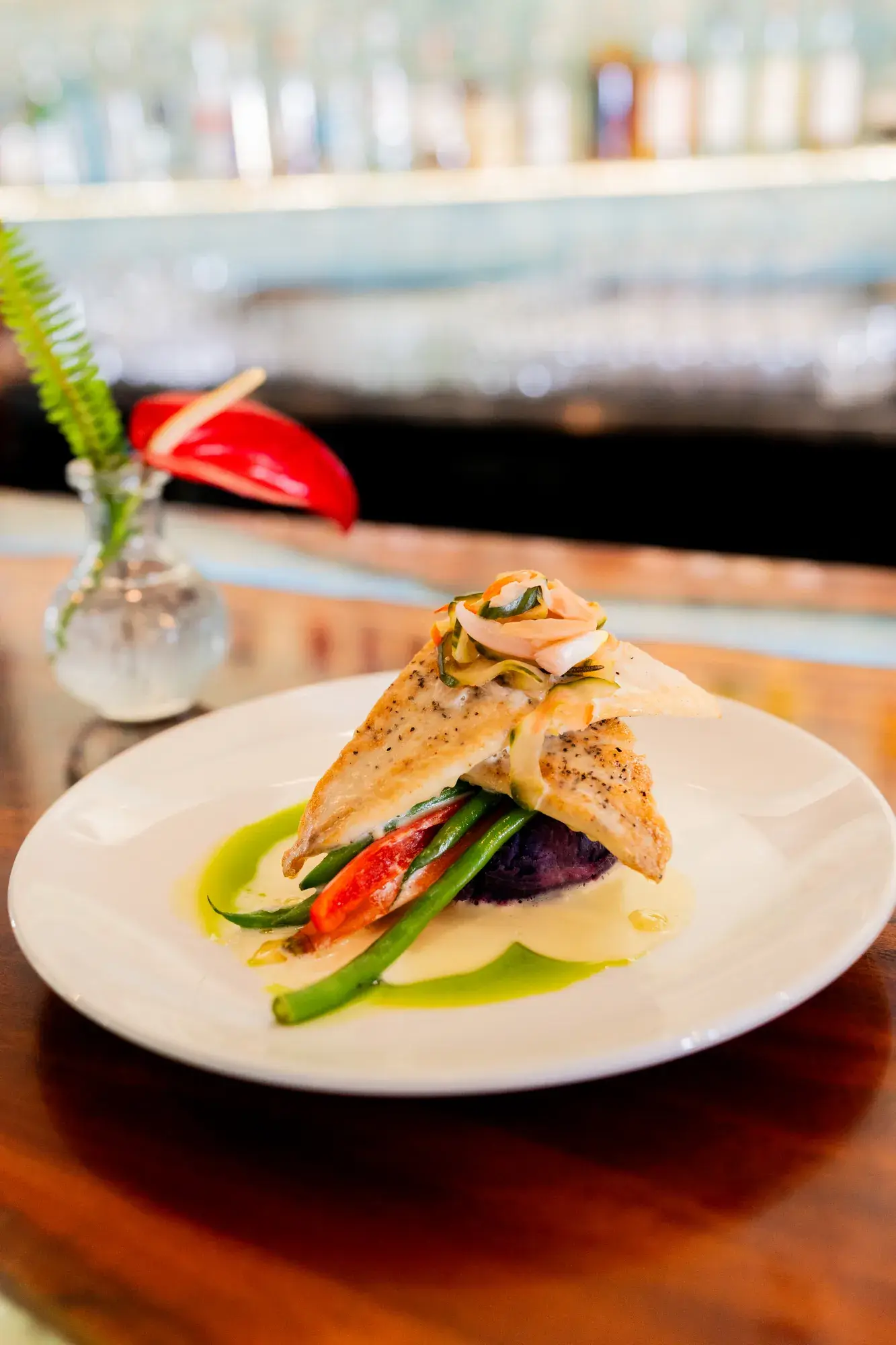 Mochiko Crusted Fresh Catch at Jackie Rey's Ohana Grill, Garlic vegetables, Molokai purple mash, ginger lime beurre blanc, umami sauce, namasu, purple potato crisps.