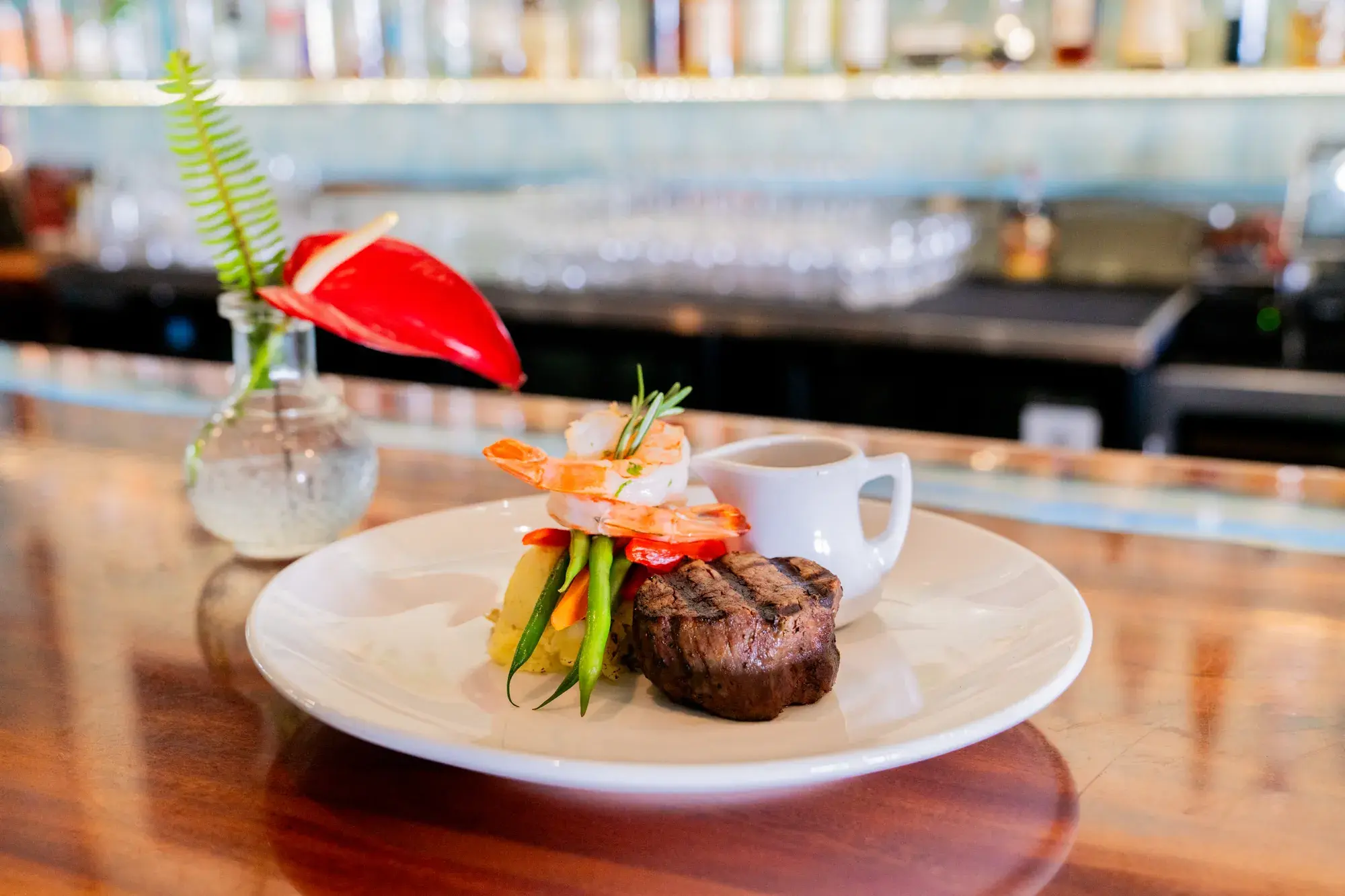 Jackie Rey's Surf & Turf at Jackie Rey's Ohana Grill, 5oz filet mignon, garlic jumbo shrimp, garlic vegetables, yuzu mash, demi-glace.